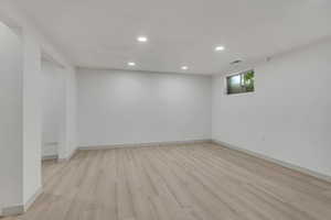 Empty room with recessed lighting and light wood-style flooring