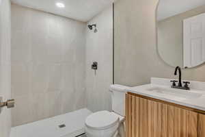 Bathroom featuring vanity and tiled shower