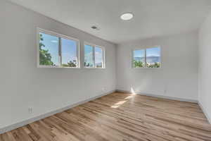 Unfurnished room featuring wood finished floors and a mountain view