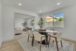 Dining area with recessed lighting and light wood finished floors