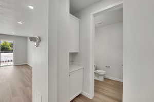 Bathroom featuring wood finished floors, a textured ceiling, and recessed lighting