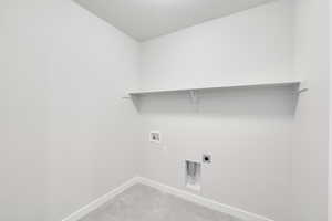 Laundry room with hookup for a washing machine and electric dryer hookup