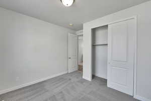 Unfurnished bedroom with carpet floors and a closet