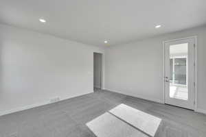 Spare room with carpet flooring and recessed lighting