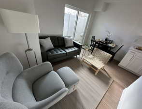 Living room with light wood-type flooring and baseboards