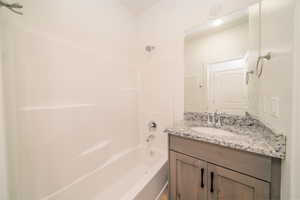 Bathroom featuring vanity and bathtub / shower combination