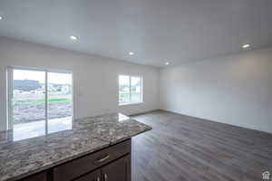 Unfurnished dining area featuring wood finished floors and recessed lighting