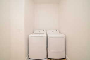 Laundry room featuring independent washer and dryer and baseboards