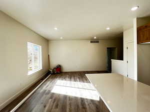 Unfurnished dining area with recessed lighting and dark wood-style flooring