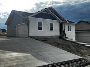 Ranch-style house featuring an attached garage and driveway
