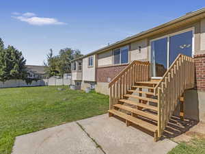 Rear view of house featuring stucco siding and brick siding
