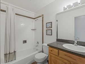 Full bathroom featuring shower / bath combo and vanity