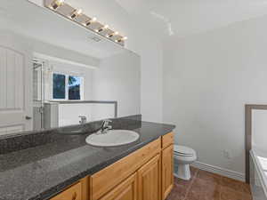 Bathroom featuring vanity, tile patterned floors, and a shower with shower door