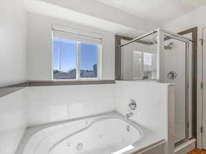 Bathroom featuring a shower stall and a whirlpool tub