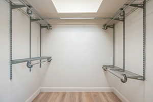 Walk in closet featuring light wood-style floors
