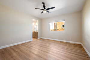 Spare room with light wood-type flooring and ceiling fan