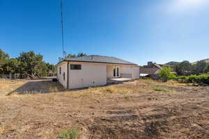 Rear view of house featuring a patio area and stucco siding