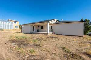 Back of house with a patio, french doors, and stucco siding