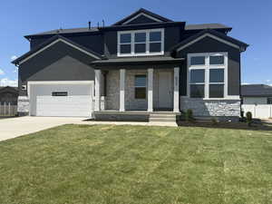View of front of home featuring stone siding, stucco siding, driveway, and a porch