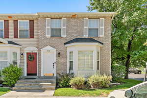 Colonial home featuring brick siding