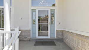 Entrance to property with stone siding and stucco siding
