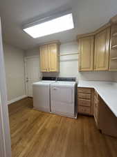 Laundry room with lots of storage, washer and dryer INCLUDED, and garage access