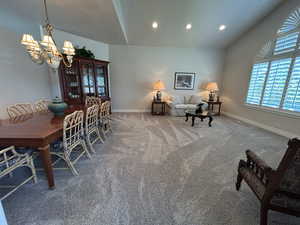 Living/Dining Room to the right of Entry with newer carpet, chandelier, recessed lighting, and high vaulted ceiling