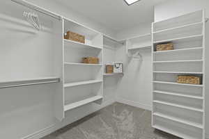 Walk in closet with light carpet