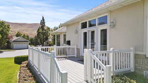 Deck featuring a mountain view and a lawn