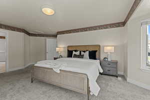 Carpeted bedroom featuring a textured ceiling and multiple windows