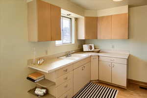 Kitchen featuring light countertops, light wood-type flooring, and open shelves
