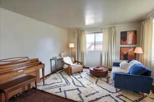 Sitting room featuring carpet floors