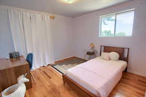 Bedroom featuring light wood-style flooring and baseboards