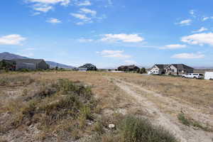 View of dirt / gravel road featuring a mountain view
