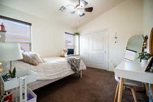 Bedroom featuring vaulted ceiling, carpet, a closet, and ceiling fan