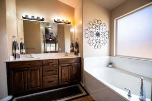 Full bathroom with a bath and double vanity
