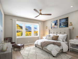 Bedroom with light wood finished floors, a ceiling fan, recessed lighting, and baseboards