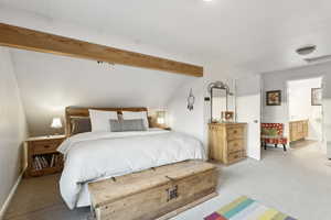 Carpeted bedroom with ensuite bathroom