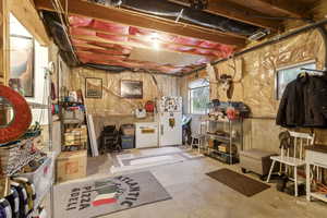 Basement with freestanding refrigerator and white fridge