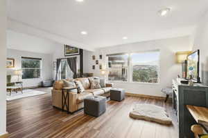 Living area featuring wood finished floors, lofted ceiling, and recessed lighting