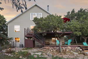 Rear view of property with a patio, stairs, and a deck