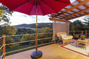 Wooden deck with a mountain view and a pergola