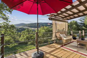 Wooden deck with a mountain view and a pergola