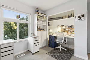 Home office featuring baseboards and light carpet