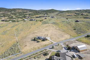 Aerial overview of property's location featuring rural landscape and a mountainous background