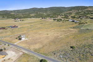 Aerial view of property's location featuring rural landscape and a mountainous background