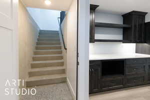 Staircase featuring speckle patterned floor