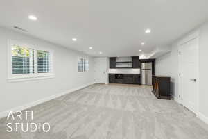 Unfurnished living room with recessed lighting and light carpet