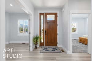 Entryway with wood finished floors and baseboards