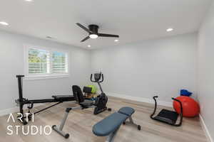 Workout area featuring wood finished floors, recessed lighting, and a ceiling fan
